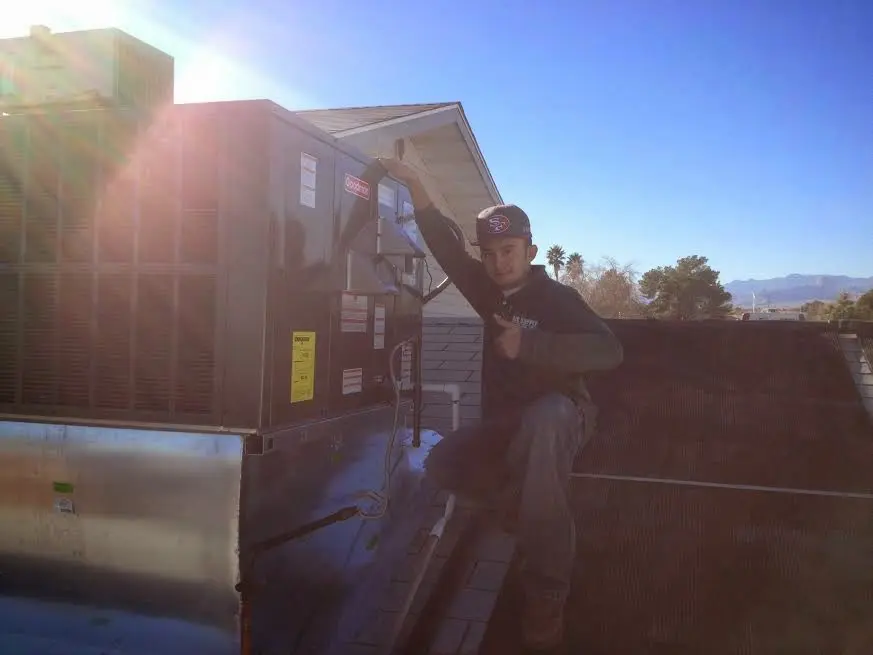 HVAC technician performing Boiler Repair on a rooftop unit in Beachwood